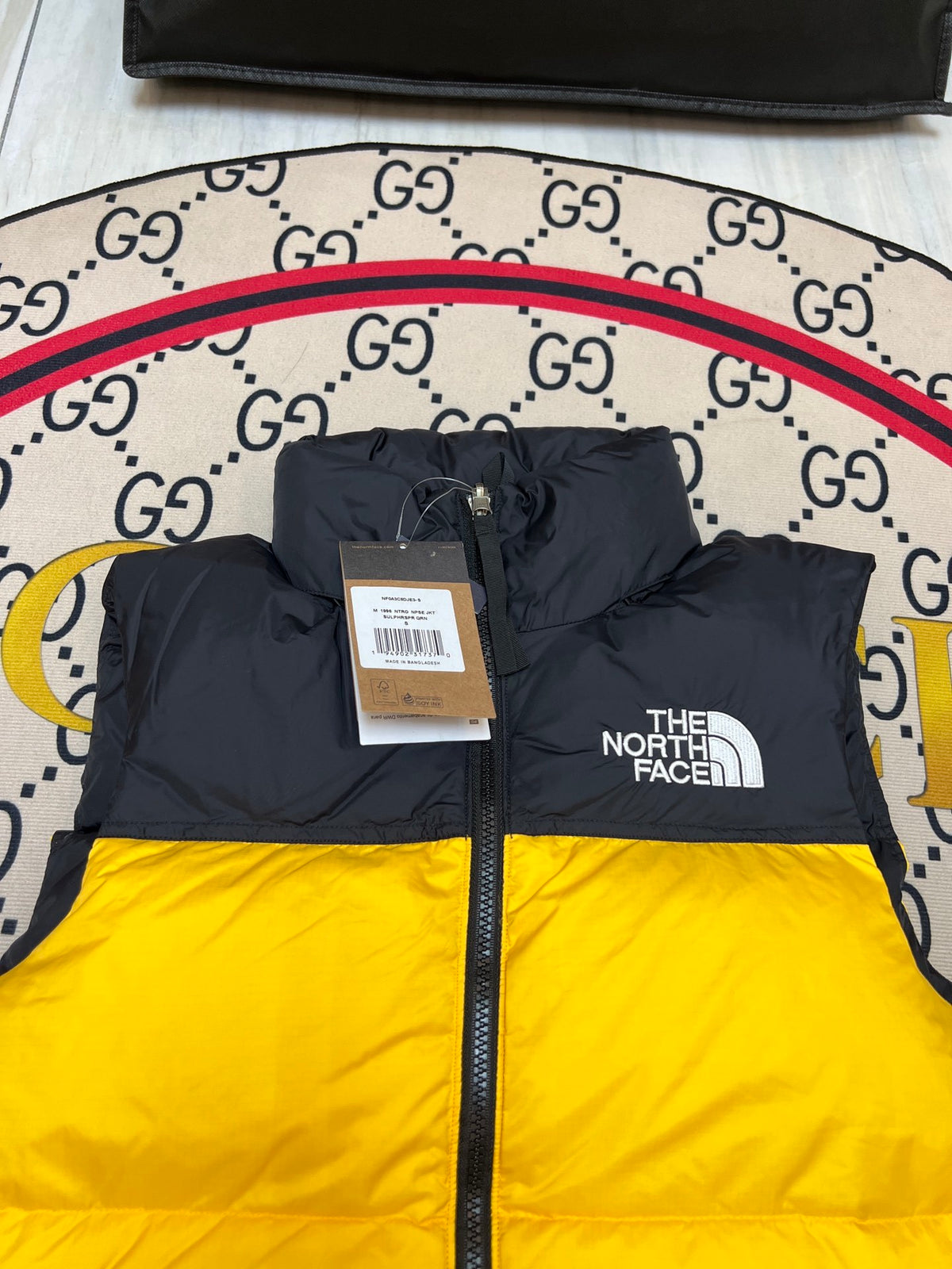 The North Face Yellow and Black Colorblock Puffer Vest